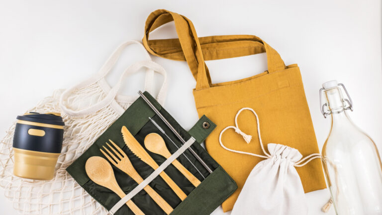 Reusable items like water bottles and cloth bags for affordable sustainable living.